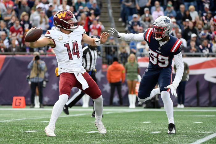 Nov 5, 2023; Foxborough, Massachusetts, USA; Washington Commanders quarterback Sam Howell (14) gets set to throw a pass while New England Patriots linebacker Josh Uche (55) defends during the first half at Gillette Stadium.